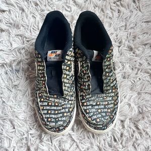 Black Nike Air Force 1’s with JustDoit print with creasing
